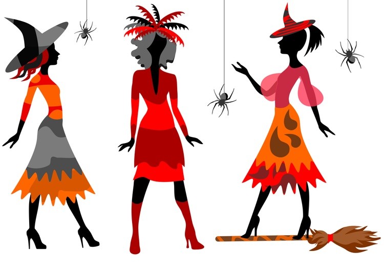 Three girls in Halloween costumes with a broom and spiders