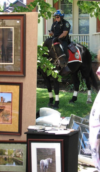 Mounted policeman at art festival and posters