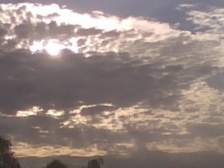 Storm clouds cover the early morning sun