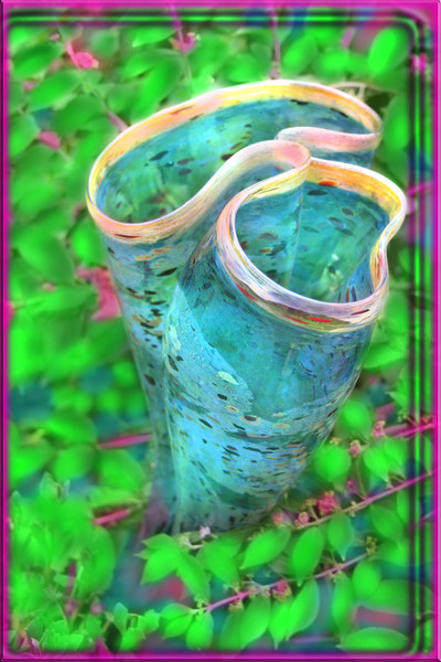 BLUE VASE IN GREEN LEAVES BY CHIHULY