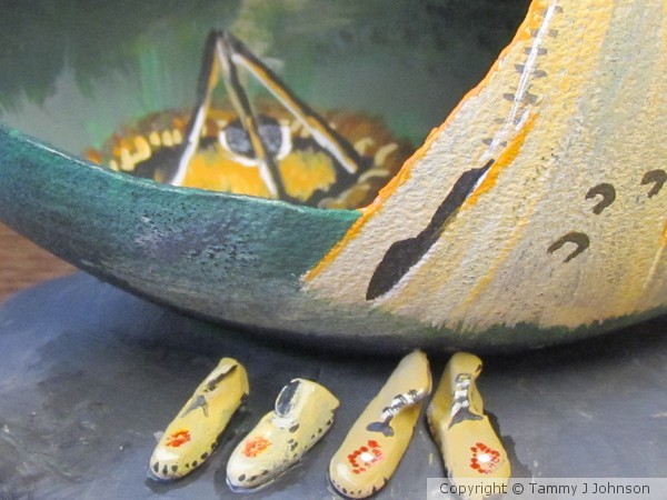 Tepee, moccasins and fire pit on cut emu egg