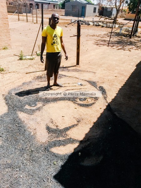 ground art portrait. black sand on ground