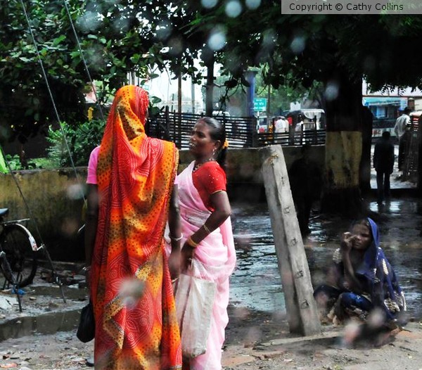 Women chatting in the rain Kolkatta India