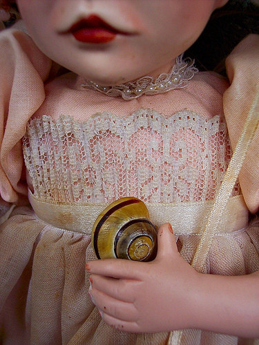 Doll Holding Snail Shell