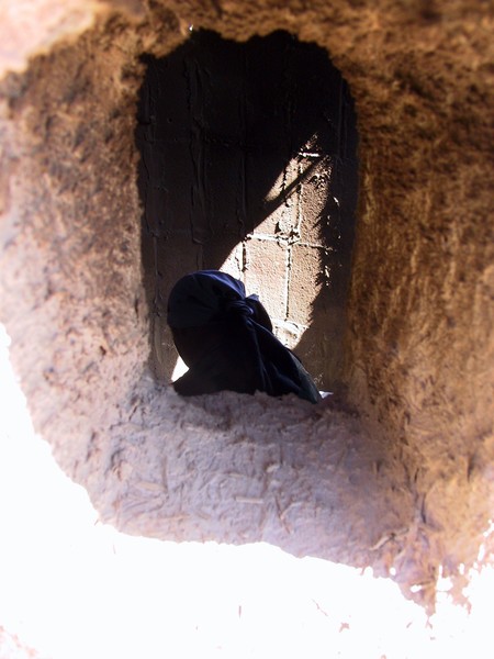 A Bedouin woman at a window