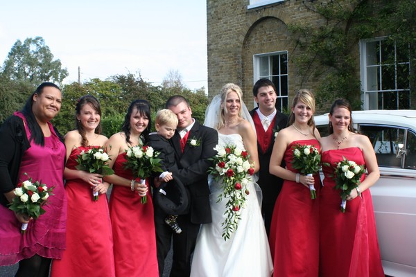 Bride, groom, their son, best man and bridesmaids