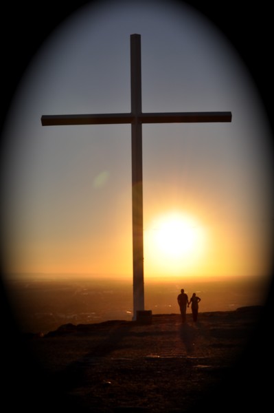Cross and couple in the sunset