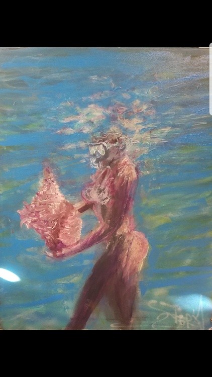 Lady swimming with shell