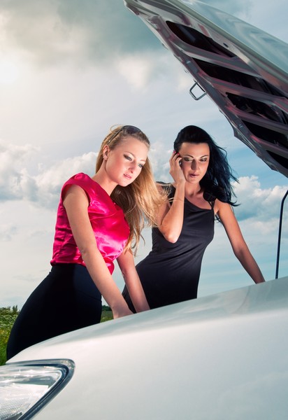 Two young women with broken car- SmartPhotoEditors