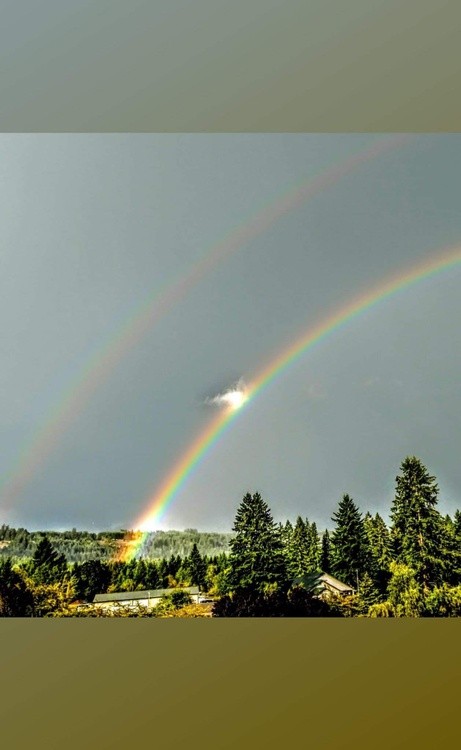Triple rainbows with an angel riding one