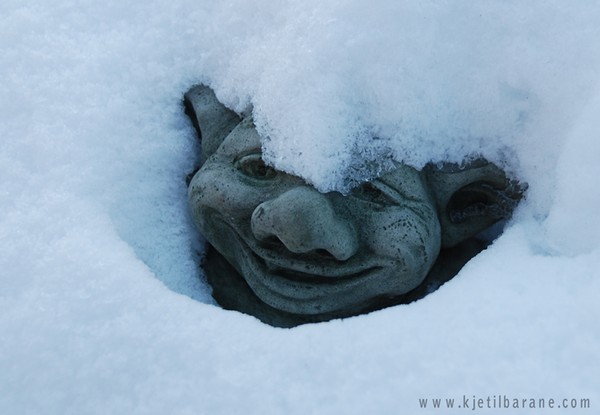 Troll looking up from the snow