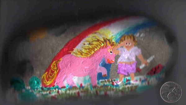 child and pink pony