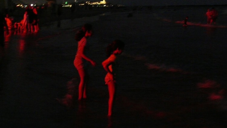 Red Figures on the Beach