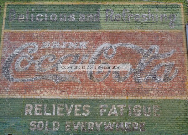 Coca Cola Sign on Brick Wall