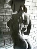 Young woman in front of wall