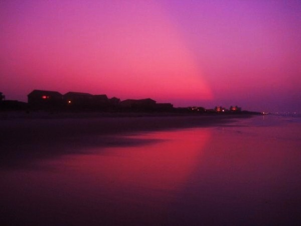 The shore reflects the sky.