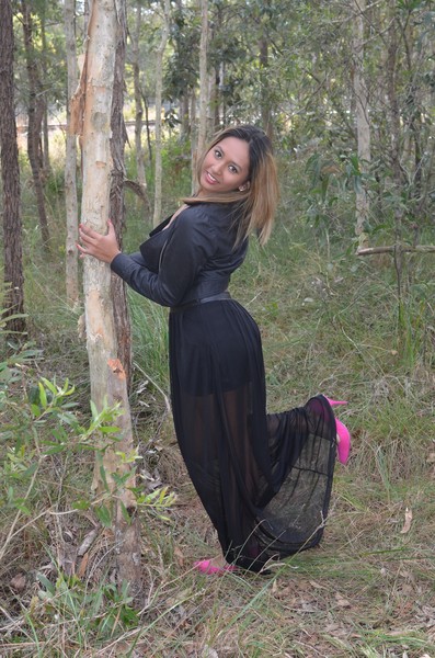 Young lady standing among the paper bark trees