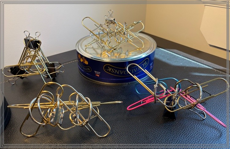 24 Giant Metal Paper Clips and a Tin of Butter Biscuits