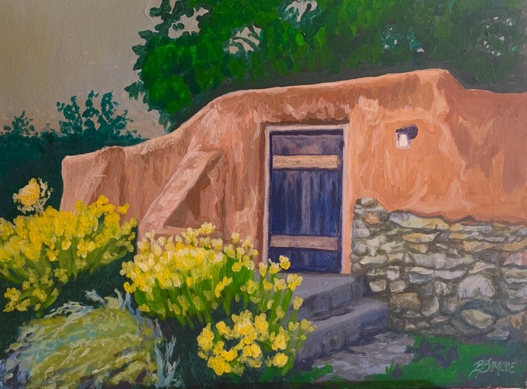 Adobe with blue door and yellow flowers