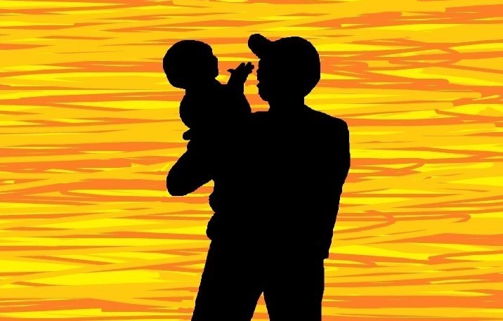 A Silhouetted Father Holding His Child
