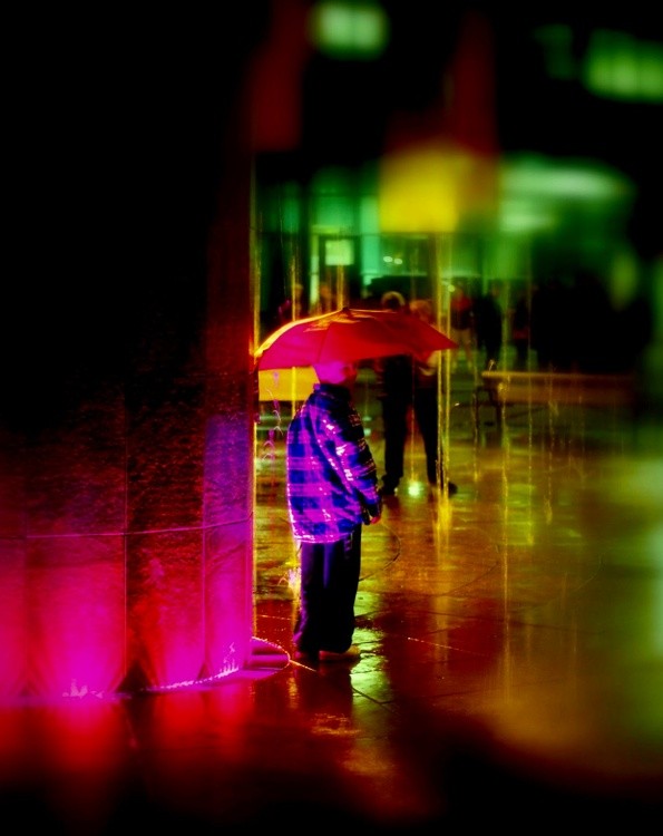 Boy in rain with ghosts