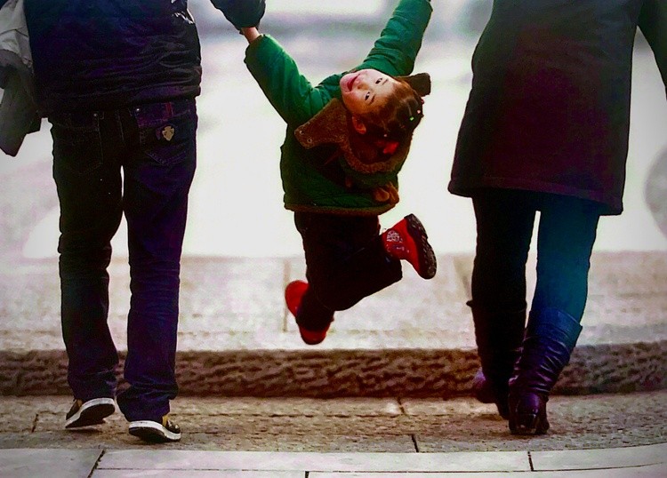 Pure Joy – A Child’s Playful Moment in Midair