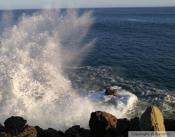 Ocean waves crash on rocks