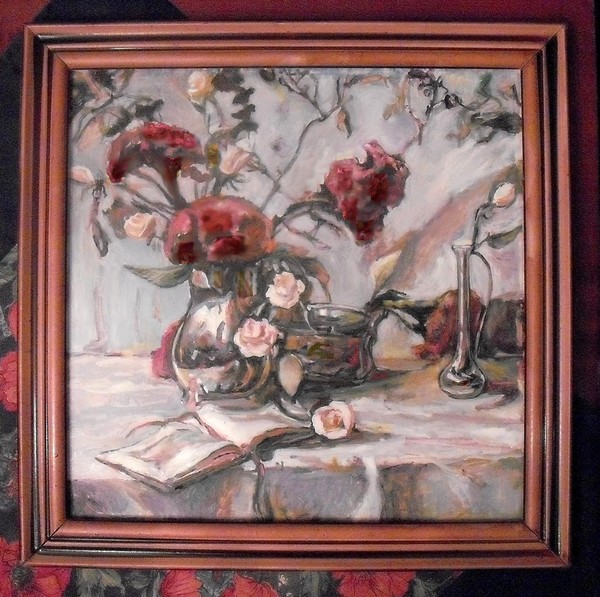 Still life with red flowers and old book