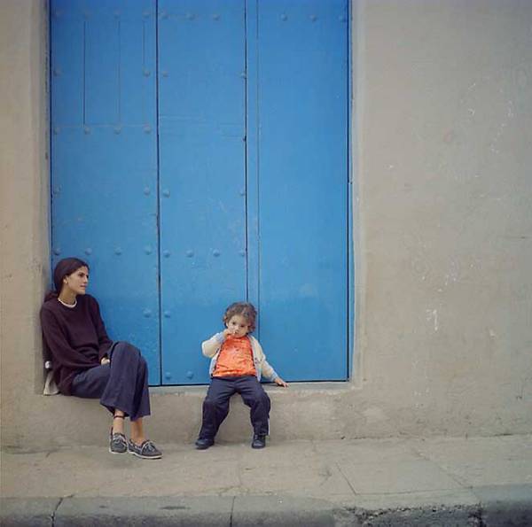 blue door with woman and child 
