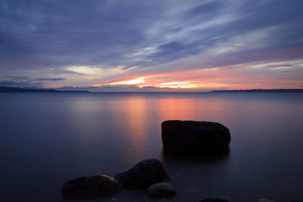 glassy water with glowing sunset