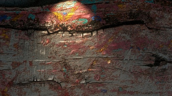 An Old Board With Paint On It.