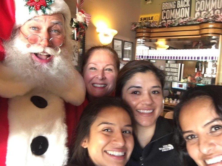 red sled santa with girls