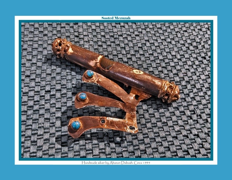 A sooted mezuzah, which was cleaned