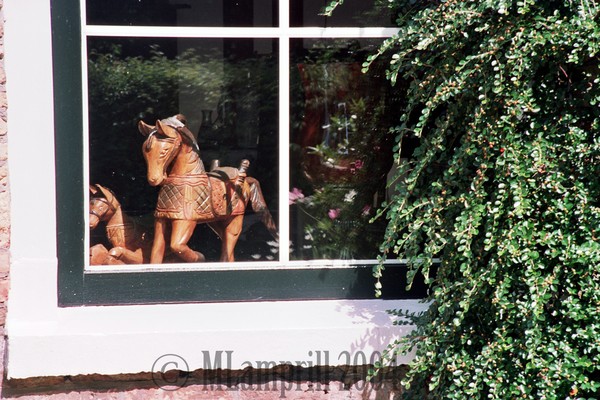 Wooden horse in window