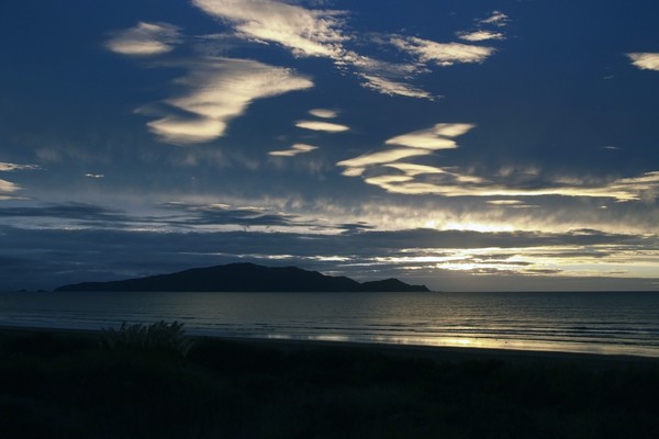 as the sun sets over Kapiti Island