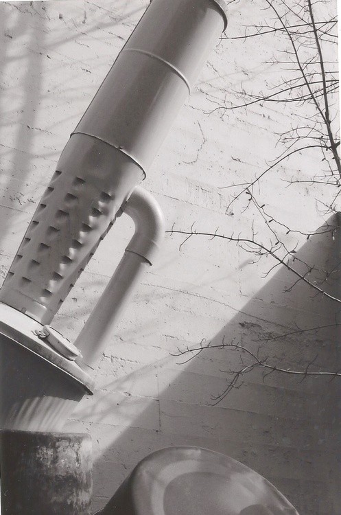 black and white garbage can wood stove