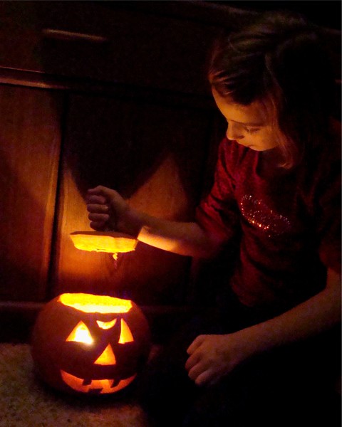Keghan Enthralled With Her Jack-O-Lantern