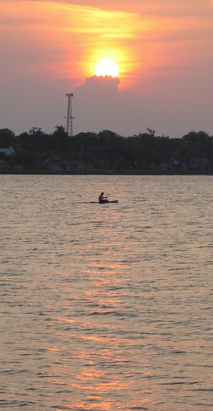 Lone kayaker at sunset