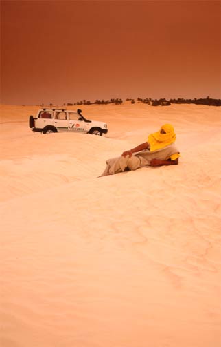 Arab & car in desert scene
