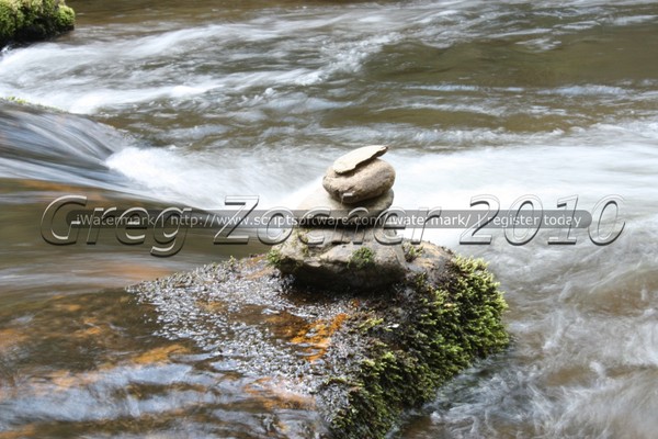 Stacked rock on river