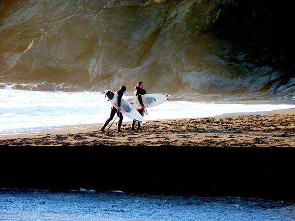 Surfers towards the west