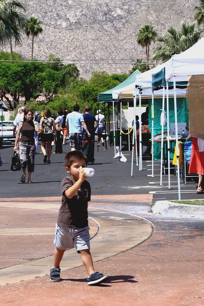 Little Boy Having a Drink at Farmer's Market
