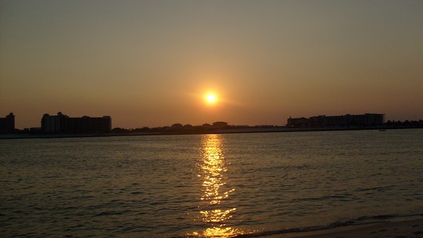 sunset on the water at orange beach