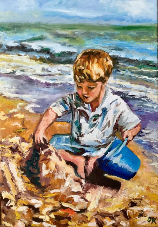 Boy is making a sand castle