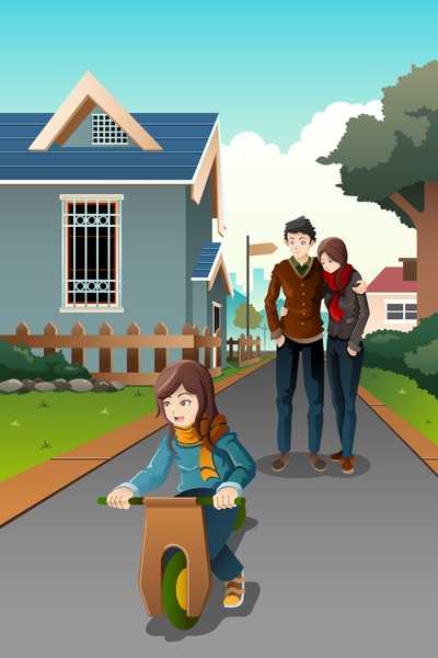 Parents watching their child riding a homemade bik
