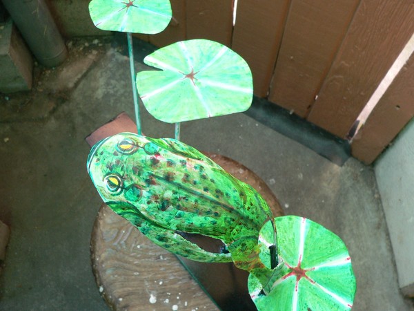steel bullfrog jumping from pad