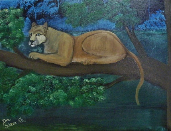 Florida Panter Resting in a tree over a lake
