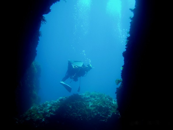 Diver at the entrance to the cave