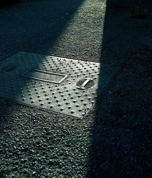 Setting sun and manhole cover