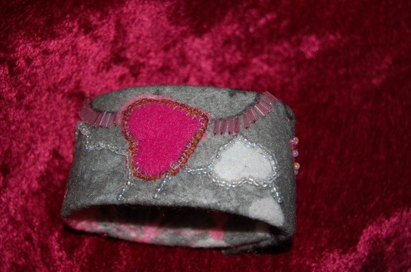 Bracelet with stitching and hand beading.